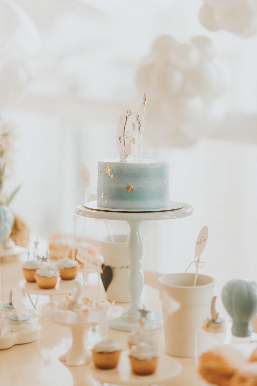 Soft pastel christening dessert table with cake